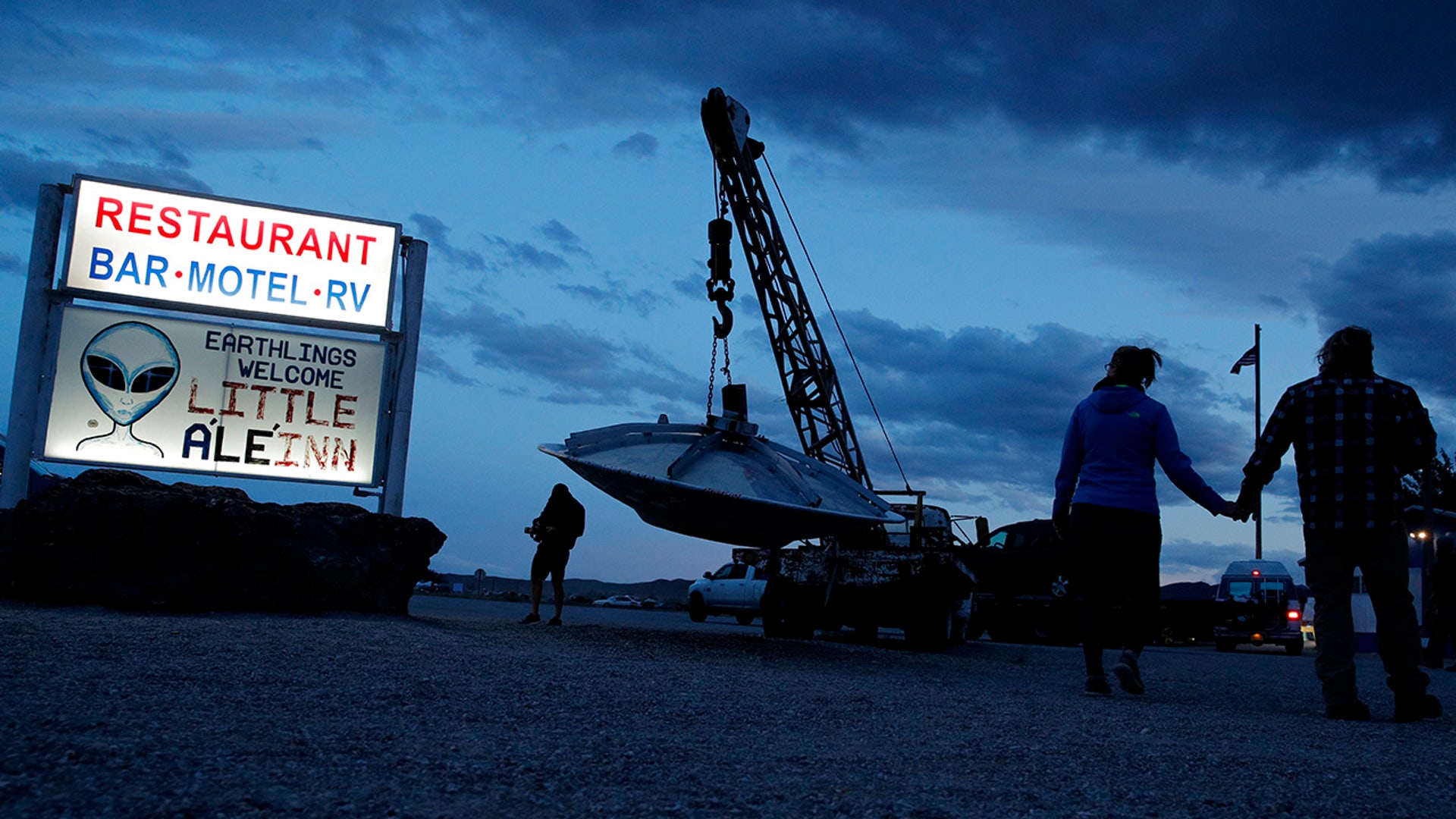 People walk near the Little A'Le'Inn during an event inspired by the "Storm Area 51" internet hoax, Thursday, Sept. 19, 2019, . (AP Photo/John Locher)