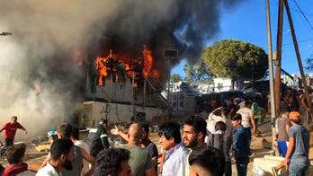 Migrants set fire to Greek refugee camp; at least one is killed, authorities say