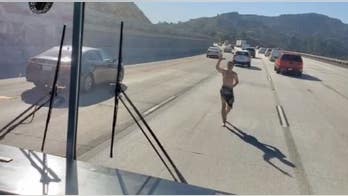 Video shows nearly naked man trying to force his way into school bus on California freeway