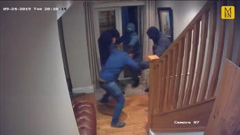 Surveillance video shows outnumbered homeowner fight off intruders with bare hands: report