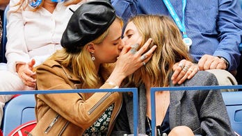 Cara Delevingne kisses Ashley Benson as they watch Serena Williams at US Open