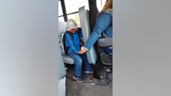 Crying boy comforted by bus driver in touching photo from first day of school