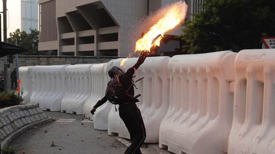 Hong Kong police deploy water cannons amid clashes with protesters in 15th consecutive weekend of unrest