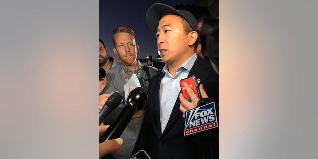 Democratic presidential candidate Andrew Yang speaks with reporters following a campaign rally in Boston on Sept. 16, 2019
