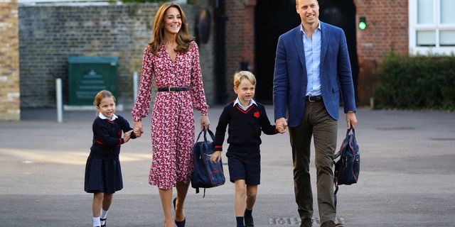 Britain's Princess Charlotte, left, with her brother Prince George and their parents Prince William and Kate, Duchess of Cambridge, arrives for her first day of school at Thomas's Battersea in London, Thursday, Sept. 5, 2019.