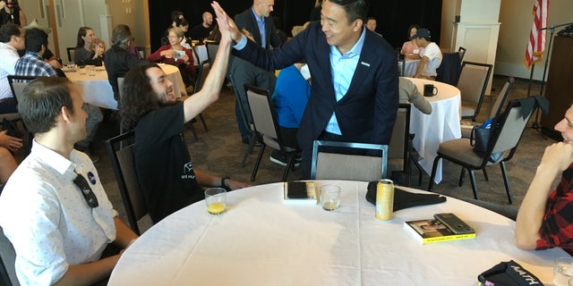 Democratic presidential candidate Andrew Yang greets audience members at a chamber of commerce event in Portsmouth, N.H., on Sept. 27, 2019