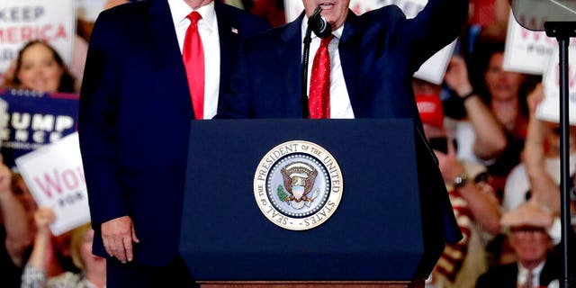 President Donald Trump, left, gives his support to Dan Bishop, right, a Republican running for the special North Carolina 9th District U.S. Congressional race as he speaks at a rally in Fayetteville, N.C., Monday, Sept. 9, 2019. (AP Photo/Chris Seward)