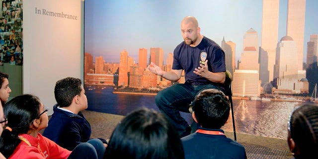 This image released by HBO shows a New York City Fireman speaking to children in a scene from the documentary "What Happened on September 11," a short film directed at young people to explain to them what happened on Sept. 11, 2001. The program debuts on Wednesday.