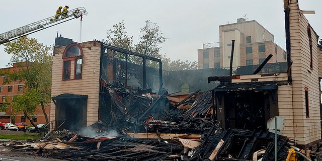 Firefighters working on the scene of the fire that ravaged and destroyed a synagogue in downtown Duluth last Monday. (Brooks Johnson / Star Tribune via AP)