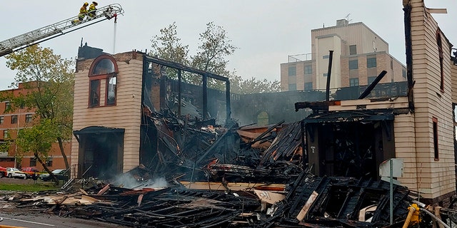 Firefighters working on the scene of the fire that ravaged and destroyed a synagogue in downtown Duluth last Monday. (Brooks Johnson / Star Tribune via AP)