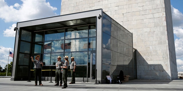 National Parks Service park rangers gather outside a new security screening building at the foot of the Washington Monument during a preview tour ahead of the monument's official reopening, Wednesday, Sept. 18, 2019, in Washington. The monument, which has been closed to the public since August 2016, is scheduled to re-open Thursday, Sept. 19. (AP Photo/Patrick Semansky)