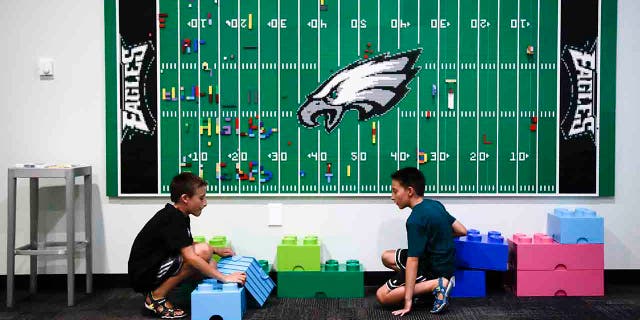 In this Thursday, Aug. 22, 2019, photo, 10-year-old twin brothers Ryan left, and Jack Ykoruk, play in the Lincoln Financial Field sensory room before a preseason NFL football game between the Philadelphia Eagles and the Baltimore Ravens in Philadelphia. (AP Photo/Matt Rourke)