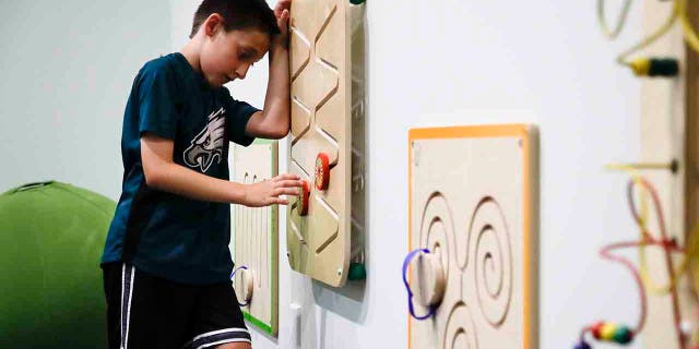 In this Thursday, Aug. 22, 2019, photo, 10-year-old Jack Ykoruk plays in the Lincoln Financial Field sensory room before a preseason NFL football game between the Philadelphia Eagles and the Baltimore Ravens in Philadelphia. (AP Photo/Matt Rourke)