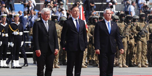 U.S. Vice President Mike Pence, right, Polish President Andrzej Duda, center and German President Frank-Walter Steinmeier stand during a memorial ceremony marking the 80th anniversary of the start of World War II in Warsaw, Poland, Sunday, Sept. 1, 2019. (AP Photo/Petr David Josek)