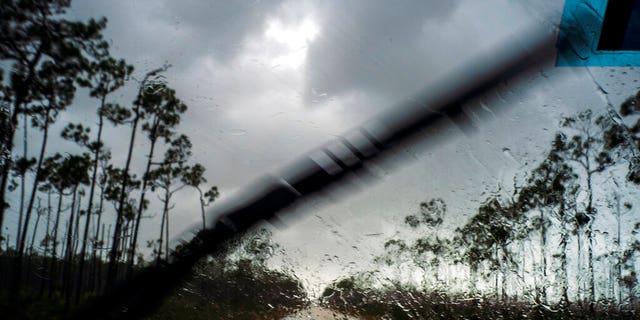 A car enters the capital in the rain before Hurricane Dorian arrives in Freeport, Grand Bahama, Bahamas on Sunday, September 1, 2019. 