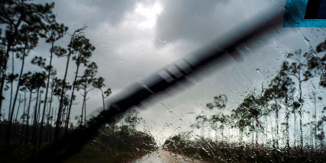 A car returns to the capital under the previous rain before the arrival of Hurricane Dorian in Freeport, Grand Bahama, Bahamas, Sunday Sept. 1, 2019.