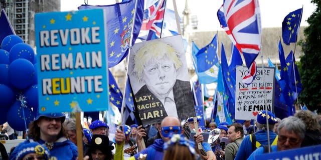 Pro-EU supporters protest outside the Houses of Parliament in London, Tuesday, Sept. 3, 2019.