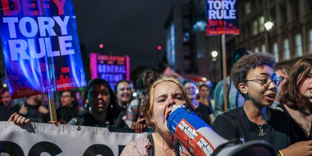 Protesters outside the House of Commons in London on Tuesday. (AP Photo/Vudi Xhymshiti)
