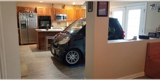 Patrick Eldridge parked his Smart car in his kitchen to protect it from Hurricane Dorian. In a Facebook post, Jessica Eldridge said her husband was "afraid his car might blow away" so he parked it in their Jacksonville home's kitchen. (Jessica Eldridge via AP)