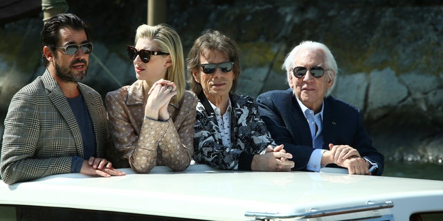 Actors Claes Bang, from left, Elizabeth Debicki, Mick Jagger or Donald Sutherland pose for photographers upon arrival for the photo call of the film 'The Burnt Orange Heresy'