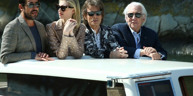 Actors Claes Bang, from left, Elizabeth Debicki, Mick Jagger or Donald Sutherland pose for photographers upon arrival for the photo call of the film 'The Burnt Orange Heresy'