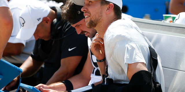 Jacksonville Jaguars quarterback Nick Foles, right, sitting on the bench after his injury Sunday. (AP Photo/Stephen B. Morton)