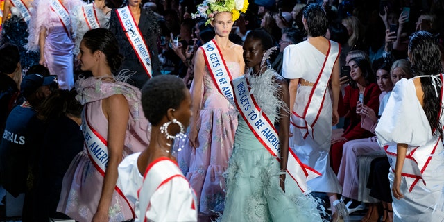 Models sported flower crowns and also carried bunches in baskets and bouquets, as if the blooms were "welcoming different kinds of people in this world, in this country."