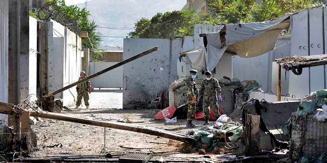 Afghan security forces work at the site of a suicide attack near the U.S. Embassy in Kabul, Afghanistan, Tuesday, Sept. 17, 2019. (AP Photo/Ebrahim Noroozi)