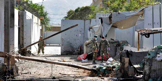 Afghan security forces work at the site of a suicide attack near the U.S. Embassy in Kabul, Afghanistan, Tuesday, Sept. 17, 2019. (AP Photo/Ebrahim Noroozi)