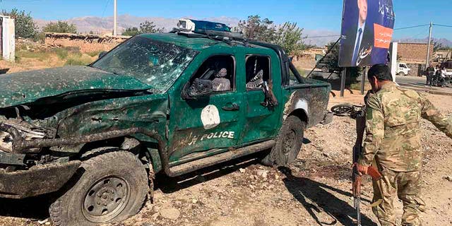 Afghan police inspect the site of a suicide attack, in Parwan province of Afghanistan, Tuesday, Sept. 17, 2019. 