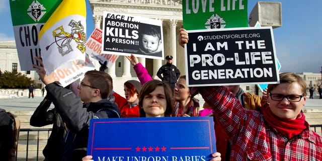 Anti-abortion activists protest outside of the U.S. Supreme Court, during last year's March for Life. (AP Photo/Jose Luis Magana, File)