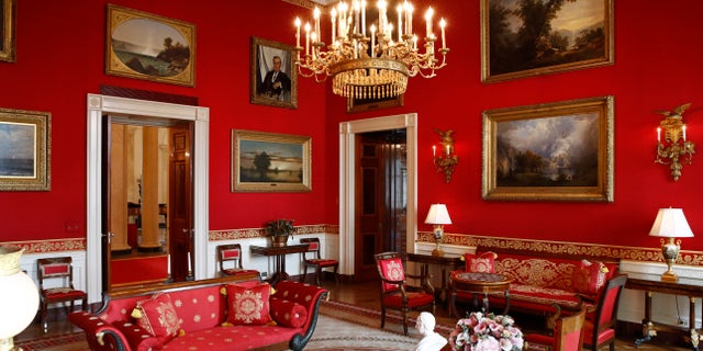 This photo shows refreshed wall fabric in the Red Room of the White House in Washington.