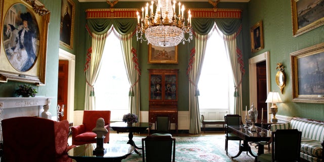 In the Green Room, draperies were repurposed by switching the backside to the front side, avoiding the cost of totally replacing the curtains, and given new fringe.