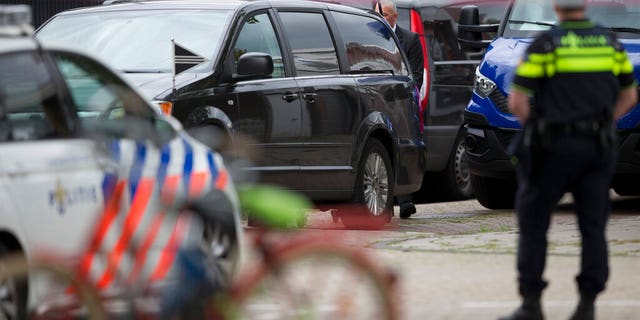 The body of a lawyer who represented a key witness in a major Dutch organized crime trial is carried into a hearse after he was gunned down in Amsterdam, in Amsterdam, Netherlands, Wednesday, Sept. 18, 2019.