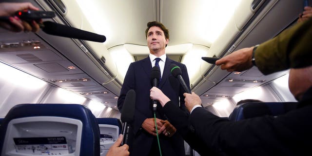 Canadian Prime Minister and Liberal Party leader Justin Trudeau makes a statement in regards to a photo coming to light of himself from 2001, wearing "brownface," during a scrum on his campaign plane in Halifax, Nova Scotia, Wednesday, Sept. 18, 2019.