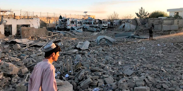 Afghan security members and people work at the site of a suicide attack in Zabul, Afghanistan, Thursday, Sept. 19, 2019. A powerful early morning suicide truck bomb devastated a hospital in southern Afghanistan on Thursday. (AP Photo/Ahmad Wali Sarhadi)