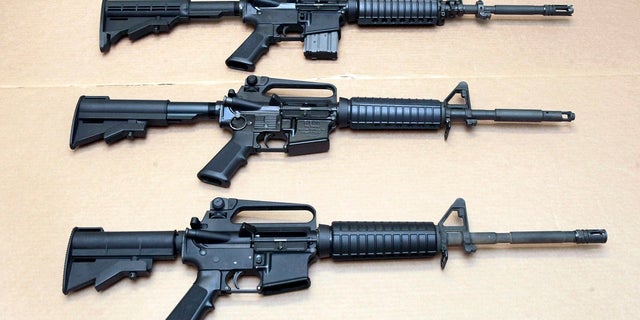 Three variations of the AR-15 rifle are displayed at the California Department of Justice in Sacramento, Calif. 