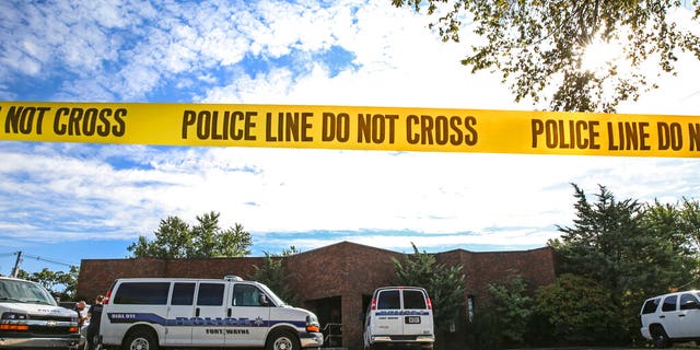 Officers from the Fort Wayne Police Department search the building that once housed an abortion clinic owned by Dr. Ulrich Klopfer. (Eric Ginnard/The Herald-News via AP)