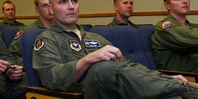 Air Force Col. Todd Hohn, foreground, and pilots assigned to the 97th Air Mobility Wing are briefed on an exercise at Altus Air Force Base, Okla.