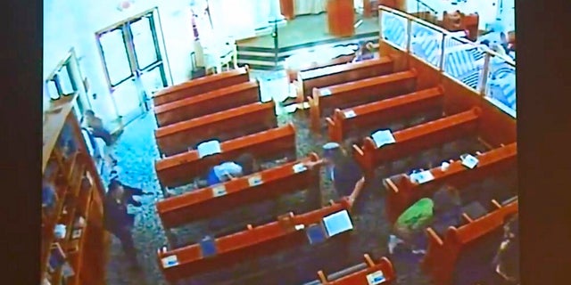 This April 27 photo from surveillance video at the Chabad of Poway shows people diving for cover as a shooting unfolds. (Chabad of Poway/San Diego Superior Court via AP)