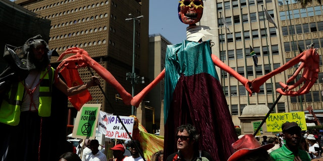 Climate protesters demonstrate outside the local government legislature's offices in Johannesburg, South Africa, Friday, Sept. 20, 2019. Protesters around the world joined rallies on Friday as a day of worldwide demonstrations calling for action against climate change began ahead of a U.N. summit in New York.