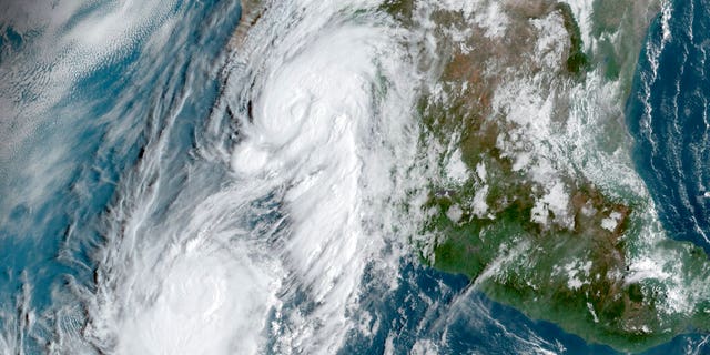 This GOES-16, GeoColor satellite image taken Friday, Sept. 20, 2019, at 14:50 UTC and provided by National Oceanic and Atmospheric Administration (NOAA), shows Hurricane Lorena, top center, followed by Tropical Storm Mario, near the southern tip of Mexico’s Baja California peninsula.