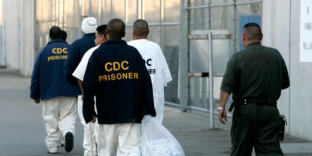 In this archive photo from January 14, 2009, newly arrived inmates are escorted to the California State Prison, Corcoran. (AP Photo / Rich Pedroncelli, File)