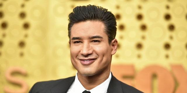 Mario Lopez shared a sweet holiday photo with his wife and their pet dog.