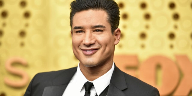 Mario Lopez shared a sweet holiday photo with his wife and their pet dog.