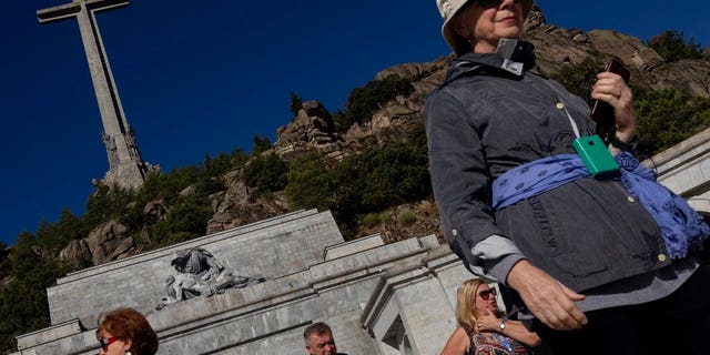 Tourists visit the Valley of the Fallen mausoleum near El Escorial, outskirts of Madrid, Spain, Tuesday, Sept. 24, 2019. Spanish Supreme Court rules that government can exhume remains of Gen. Francisco Franco. (AP Photo/Bernat Armangue)