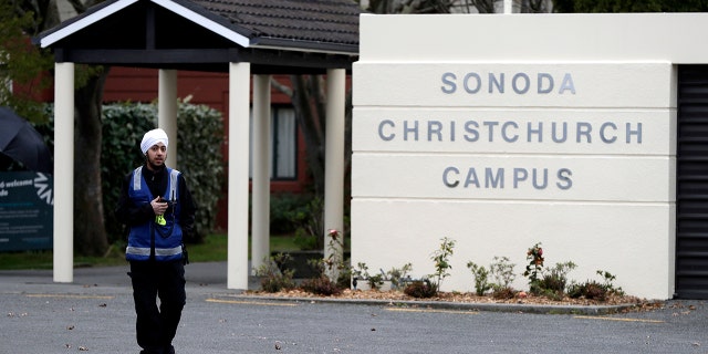 A security guard keeps watch outside student accommodation at Canterbury University in Christchurch, New Zealand, Wednesday, Sept. 25, 2019. (AP Photo/Mark Baker)