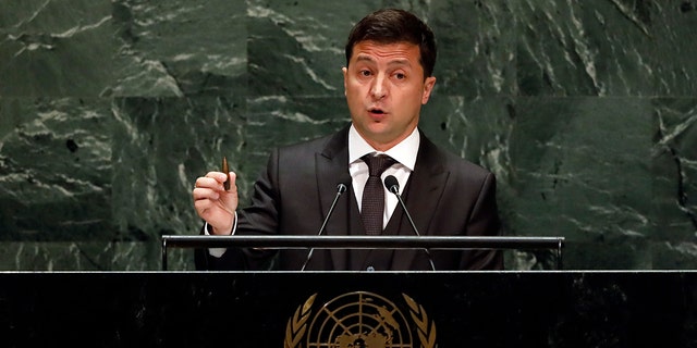 Ukraine's President Volodymyr Zelenskyy holds a bullet as he addresses the 74th session of the United Nations General Assembly, Wednesday, Sept. 25, 2019. (AP Photo/Richard Drew)