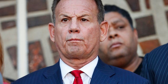 In this Jan. 11 photo, suspended Broward County Sheriff Scott Israel listens to comments by his attorney at a news conference after his suspension was announced. (AP Photo/Wilfredo Lee, File)