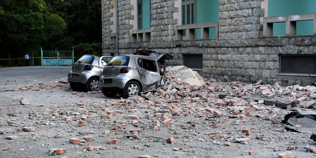 Flattened cars were parked outside the Faculty of Geology building in Tirana. (AP Photo/Hektor Pustina)